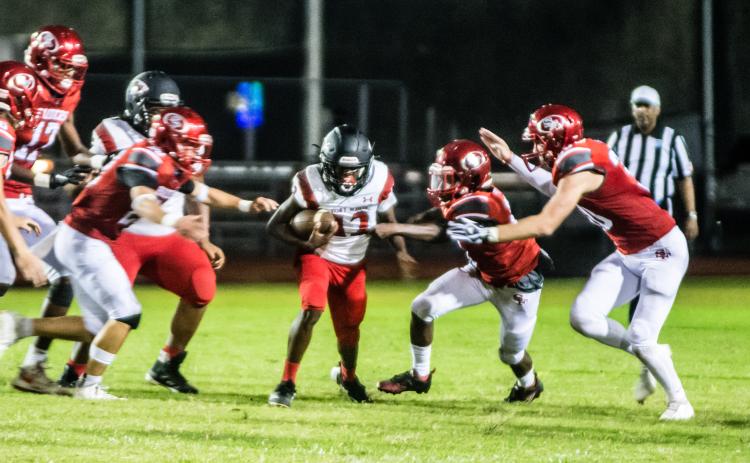 Fort White receiver Najeeb Smith is surrounded by Santa Fe defenders last week. (CHRISTINA FEAGIN/Special to the Reporter)