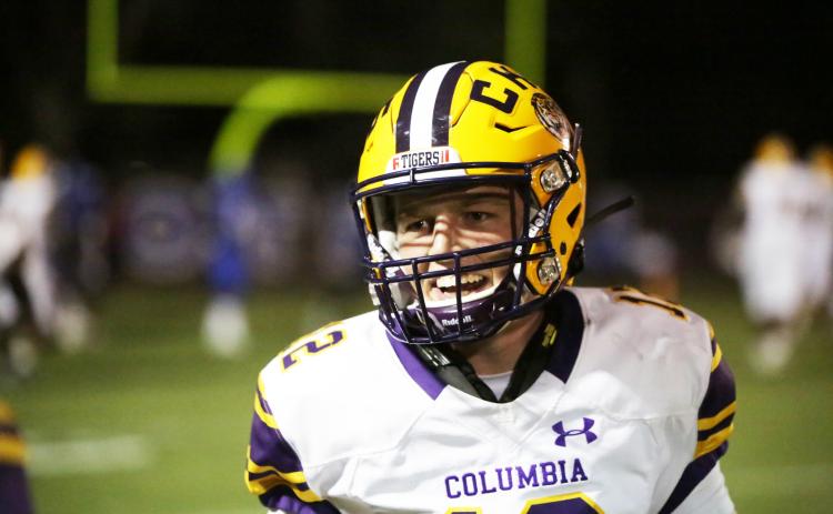 Columbia quarterback Ty Wehinger smiles coming off the field after throwing a touchdown pass last week against Trinity Christian. (BRENT KUYKENDALL/Lake City Reporter)