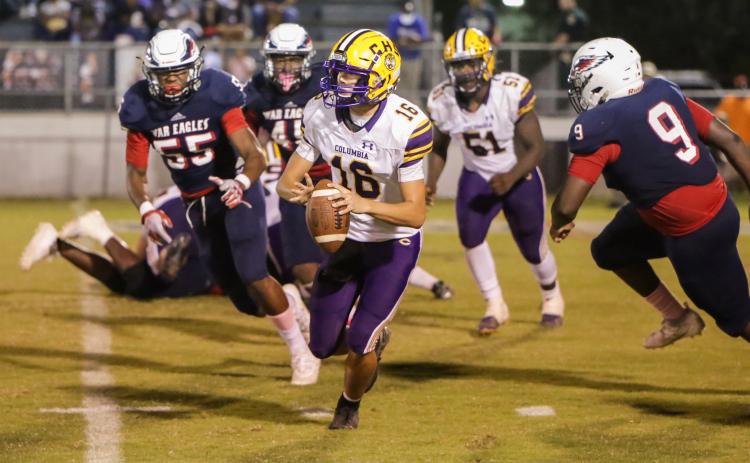 Columbia quarterback Bronsen Tillotson rolls out to pass last Friday against Wakulla. (BRENT KUYKENDALL/Lake City Reporter)