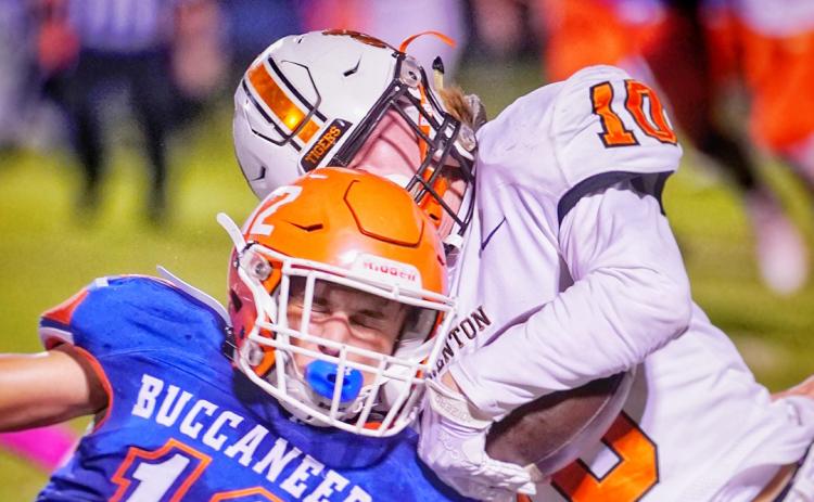 Branford’s Adrik Miller delivers a hit against Trenton’s Caleb Morgan on Friday night. (BRIAN LEWIS/Special to the Reporter)
