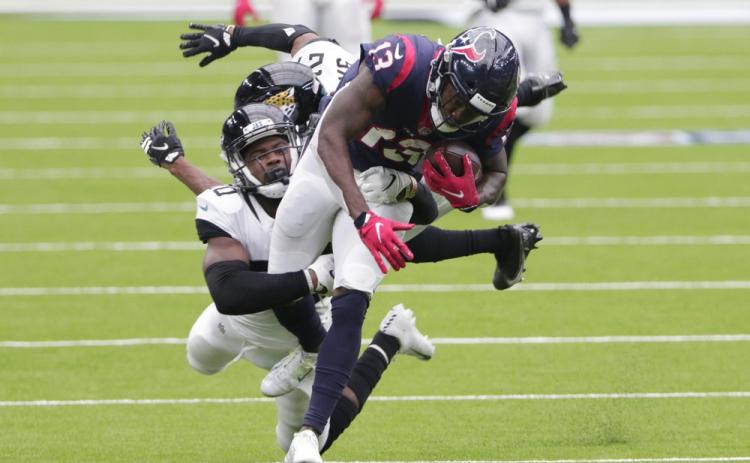 Houston Texans wide receiver Brandin Cooks (13) is hit by Jacksonville Jaguars safety Daniel Thomas (20) after a catch Sunday in Houston. (MICHAEL WYKE/Associated Press))