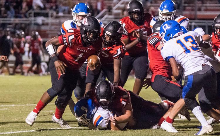 Fort White quarterback Tyler Jefferson looks for running room against Taylor County on Friday. (CHRISTINA FEAGIN/Special to the Reporter)