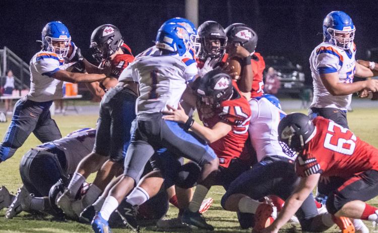 Fort White quarterback Tyler Jefferson fights to gain yardage against Taylor County on Oct. 2. (CHRISTINA FEAGIN/Special to the Reporter)