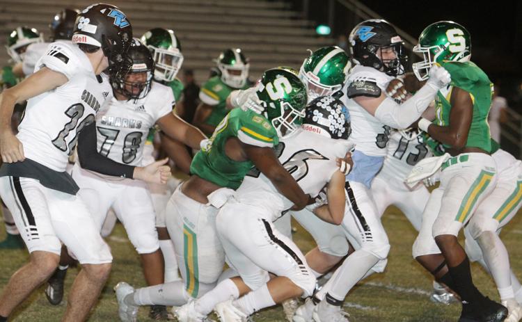 Suwannee defensive lineman Garris Reed, left, and linebacker Blaine Howard wrap up Ponte Vedra running back Campbell Parker on Friday night. (PAUL BUCHANAN/Special to the Reporter)