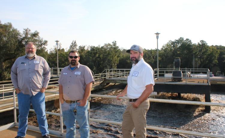 Bill Fish (from left), Tyler Todd and Cody Pridgeon stand atop a monitoring area for the aeration basin tanks at the St. Margarets Wastewater Treatment Facility on Friday morning. The aeration basin tanks  will be upgraded as part of a $6.1 million project at the facility. (TONY BRITT/Lake City Reporter)
