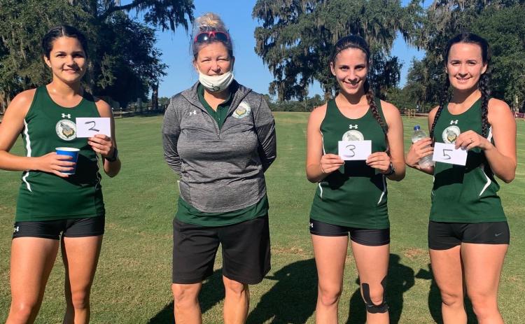 Merlin Leal (second place), Savana Thomas (third) and Amber Hollingsworth (fifth) all placed in the top five at the Tallahassee Community College Open on Saturday. Pictured are Leal (from left), FGC coach April Morse, Thomas and Hollingsworth. (COURTESY)