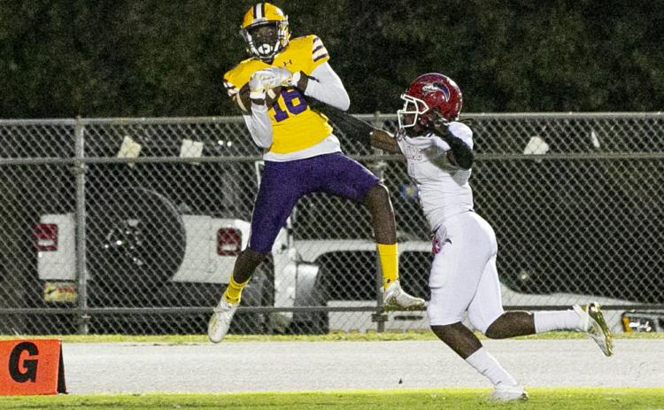 Columbia receiver Marcus Peterson catches a touchdown pass against North Miami Beach in the first quarter Friday night. Peterson also threw three touchdown passes in the fourth quarter to lead the Tigers to a come-from-behind victory. (JEN CHASTEEN/Special to the Reporter)