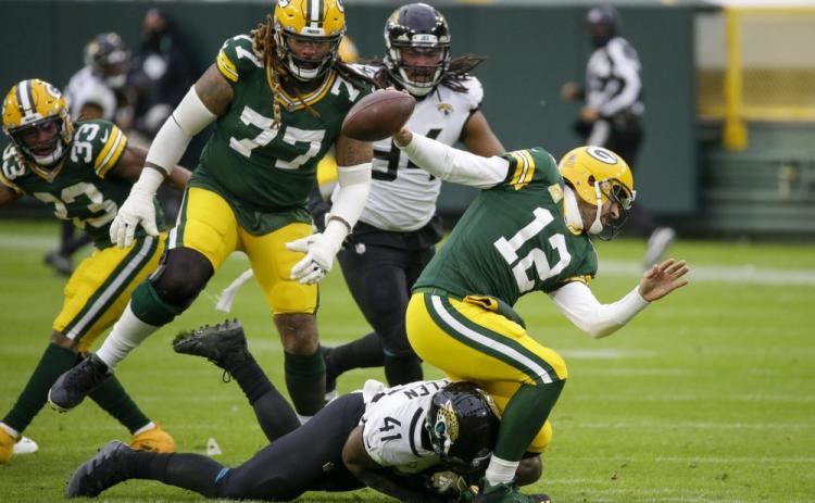 Jacksonville Jaguars' Josh Allen takes down Green Bay Packers' Aaron Rodgers on Sunday in Green Bay, Wis. Roughing the passer was called on the play. (MIKE ROEMER/Associated Press)