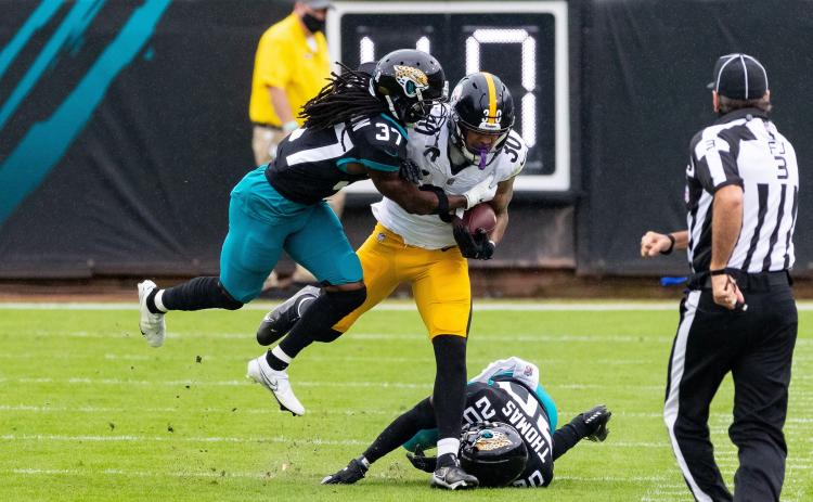 Jacksonville Jaguars cornerback Tre Herndon (37) makes the tackle on Pittsburgh Steelers running back James Conner (30) at TIAA Bank Field last Sunday in Jacksonville. (MATT PENDLETON/TNS)