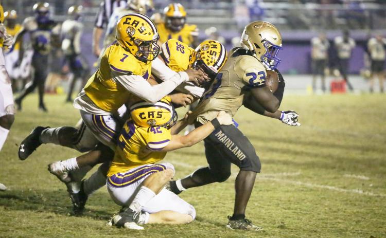 Columbia’s A’deon Farmer (7), Nate Walmsley (92) and Lane Mote (42) gang tackle Daytona Beach Mainland running back Gregory Mango during Friday’s Region 1-6A semifinal. (BRENT KUYKENDALL/Lake City Reporter)
