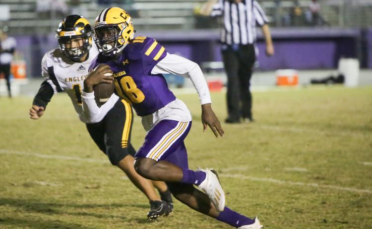 Columbia quarterback Marcus Peterson speeds past an Englewood defender during Friday’s Region 1-6A play-in playoff game. (BRENT KUYKENDALL/Lake City Reporter)