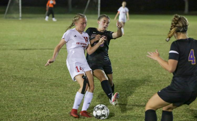 Columbia’s Isa Maranto fights for possession of the ball with Keystone Heights’ Lindsay Hovsepian on Monday night. (BRENT KUYKENDALL/Lake City Reporter)