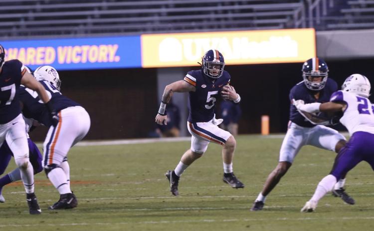 Virginia quarterback Brennan Armstrong (5) runs the ball against Abilene Christian on Nov. 21 in Charlottesville, Va. (ERIN EDGERTON/The Daily Progress via AP)