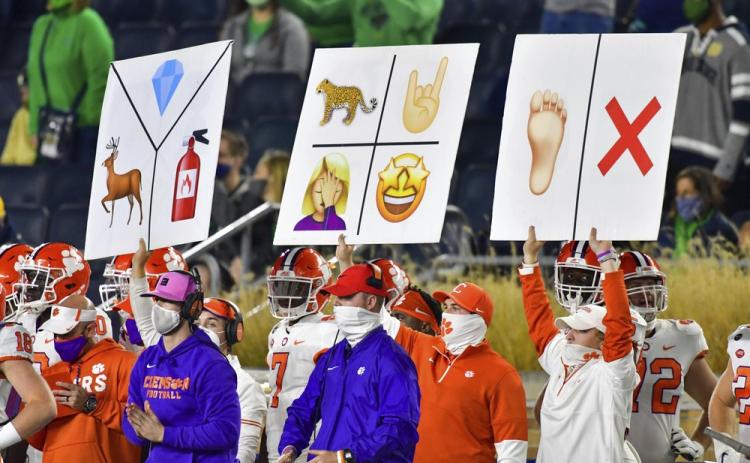 Clemson sideline personnel hold play signal cards during the third quarter of the team's game against Notre Dame on Nov. 7 in South Bend, Ind. (MATT CASHORE/AP Pool Photo)