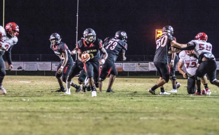Fort White running back Tavion Taylor hits the hole on a carry up the middle against Hamilton County last Friday. (CHRISTINA FEAGIN/Special to the Reporter)