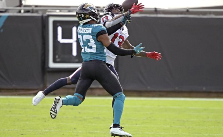 Jacksonville Jaguars cornerback CJ Henderson, left, breaks up a pass intended for Houston Texans wide receiver Brandin Cooks (13) last Sunday in Jacksonville. (PHELAN M. EBENHACK/Associated Press)