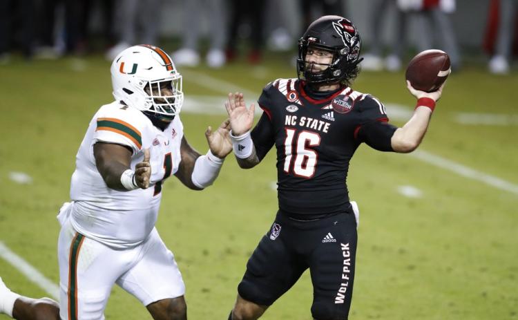 North Carolina State quarterback Bailey Hockman (16) prepares to pass while pressured by Miami defensive lineman Nesta Jade Silvera (1) on Nov. 6 in Raleigh, N.C. (ETHAN HYMAN/The News & Observer via AP, Pool)