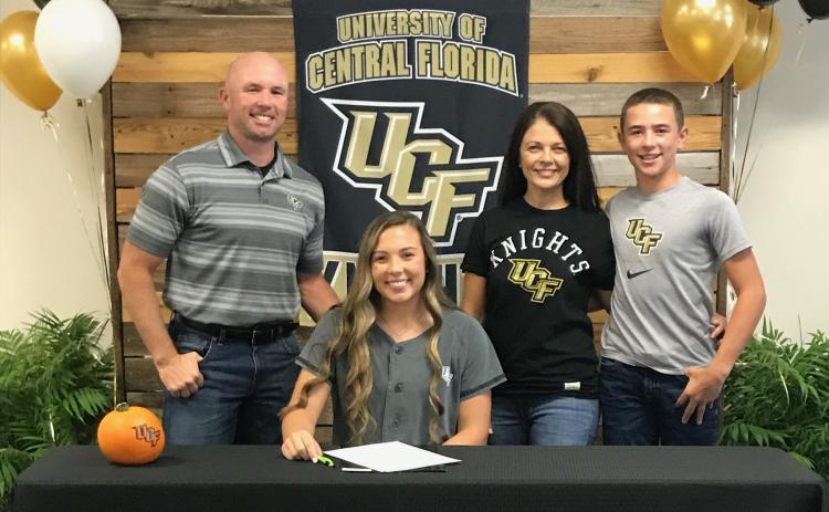 Suwannee catcher Carson Frier is pictured with her father, Todd (left), mother, Carmon (middle right) and brother Koy (far right) after signing her letter of intent with UCF on Wednesday. (COURTESY)