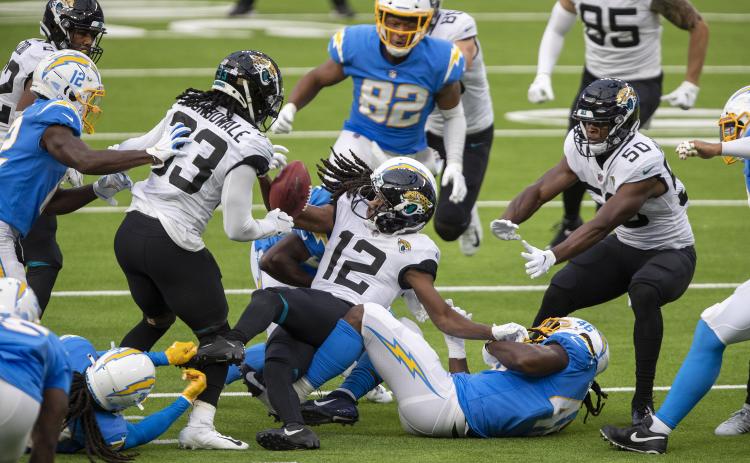 The Los Angeles Chargers' Tevaughn Campbell (37) forces the Jacksonville Jaguars' Dede Westbrook (12) to fumble on a second-half kick return at SoFi Stadium on Oct. 25 in Inglewood, California. The Chargers won, 39-29. (ALLEN J. SCHABEN/Los Angeles Times/TNS)