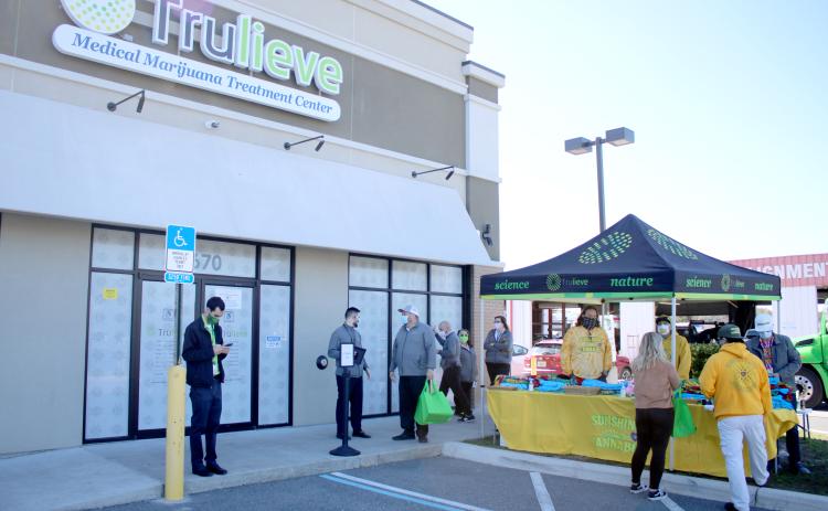 Trulieve Medical Marijuana Treatment Center customers and employees congregate around the center Wednesday morning during the facility’s grand opening. Trulieve is the first medical marijuana dispensary to open in Columbia County. (TONY BRITT/Lake City Reporter)
