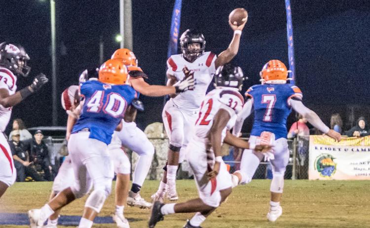 Fort White quarterback Tyler Jefferson throws a pass to Kamarion Griffin during Friday’s Region 3-1A quarterfinal against Branford. (CHRISTINA FEAGIN/Special to the Reporter)