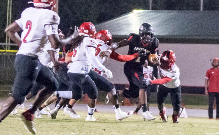 Fort White quarterback Tyler Jefferson scrambles up the field and tries to evades tackles against Hamilton County on Friday night. (CHRISTINA FEAGIN/Special to the Reporter)