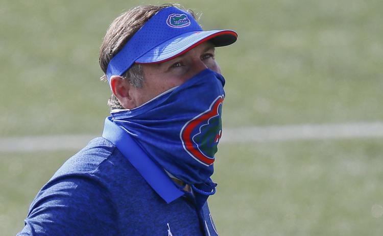 Florida head coach Dan Mullen watches his team warm up prior to a game against Vanderbilt on Nov. 21 in Nashville, Tennessee.  (FREDERICK BREEDON/Getty Images/TNS)