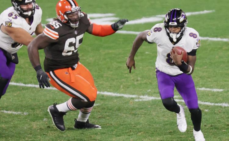 Baltimore quarterback Lamar Jackson scrambles away from pressure Monday night against Cleveland. (JOHN KUNTZ/cleveland.com/TNS)