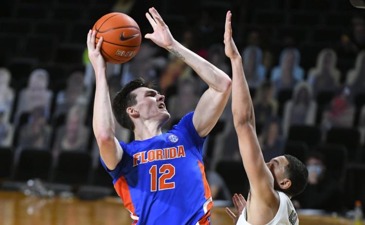 Florida forward Colin Castleton (12) shoots as Vanderbilt forward Dylan Disu defends on Wednesday in Nashville, Tenn. Florida won 91-72. (JOHN AMIS/Associated Press)