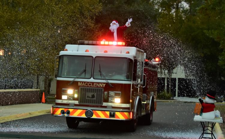 Santa Claus rides through the snow on the back of a fire truck to the Winter Wonderland at Florida Gateway College on Saturday. (ROB WOLFE/Special to the Reporter)