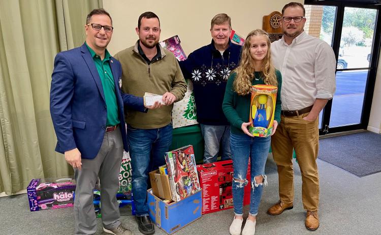 Rotary President Lee Pinchouck, Rotarian Chase Moses, Elks Toy Drive Chairman and Rotarian George Brannon, Abby Candler and Rotarian Chris Candler with monetary and toy donations given to the Elks Toy Drive. (COURTESY)