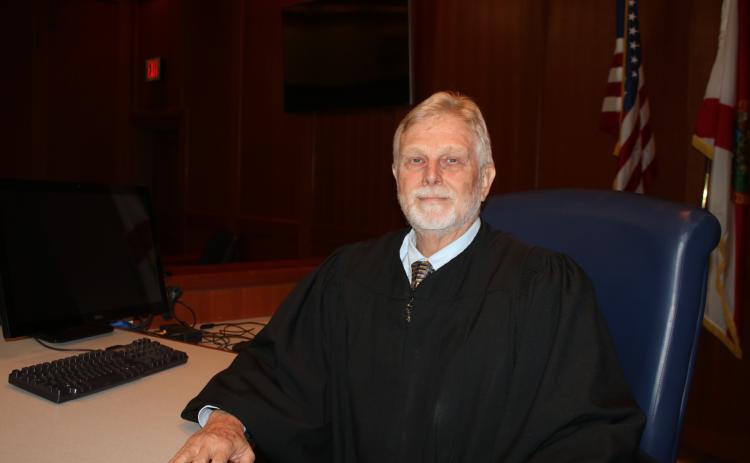 Tom Coleman, who has served as the Columbia County Judge for 18 years, sits at the bench in a Columbia County courtroom. Coleman, who has worked in the local courts system for more than four decades, retired Thursday. (TONY BRITT/Lake City Reporter)