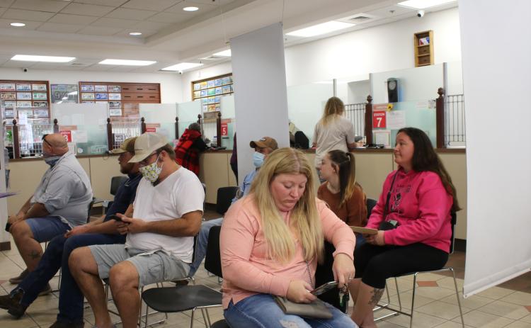 A room filled with customers await their turn at the Columbia County Tax Collectors Office on Tuesday afternoon. Activity at the office has increased as the end of the year approaches and people look to pay their taxes and other fees. The office will be closed Thursday and Friday. (TONY BRITT/Lake City Reporter)