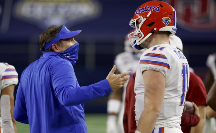 Florida coach Dan Mullen talks with quarterback Kyle Trask after Trask threw a pass into the end zone that was intercepted by Oklahoma's Woodi Washington during the first half of the Cotton Bowl on Wednesday in Arlington, Texas. (RON JENKINS/Associated Press)