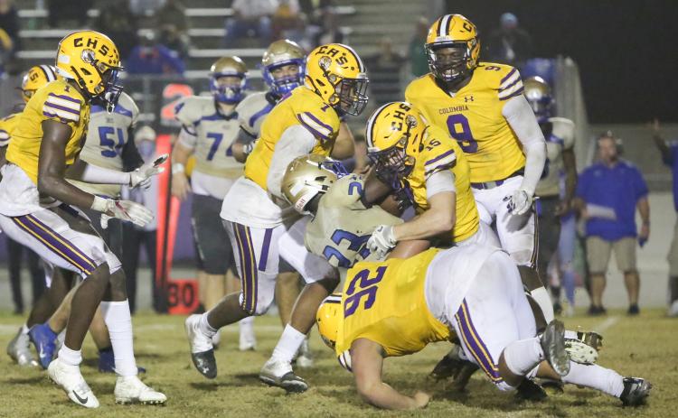 Columbia linebacker Jaden Dunn (15), defensive end A’Deon Farmer (7) and defensive lineman Nate Walmsley (92) tackle Daytona Beach Mainland running back Gregory Mango during last Friday’s Region 1-6A semifinal. (BRENT KUYKENDALL/Lake City Reporter)