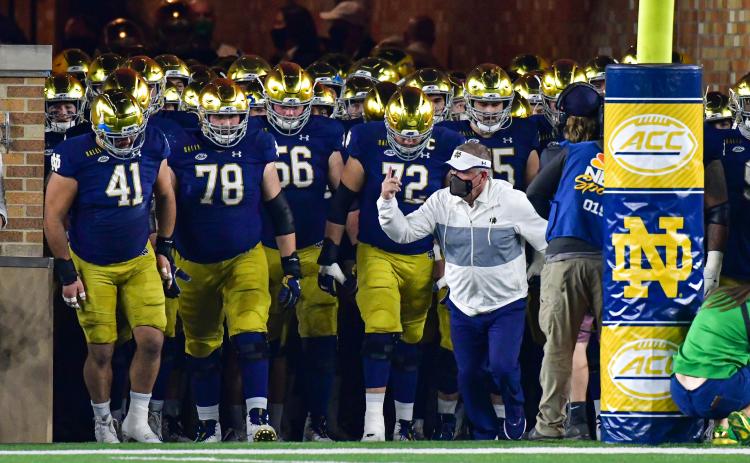 Notre Dame head coach Brian Kelly, leading the Fighting Irish out of the tunnel before a game against Clemson at Notre Dame Stadium on Nov. 7, 2020, in South Bend, Indiana, was named the Atlantic Coast Conference Coach of the Year. (MATT CASHORE/Pool/Getty Images/TNS)