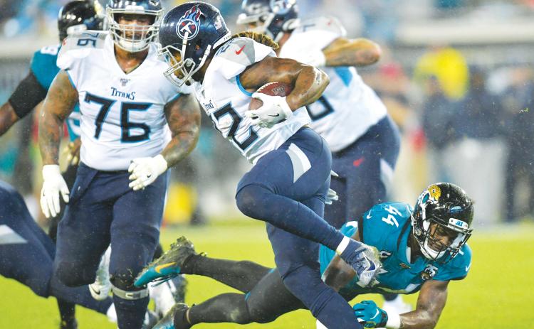 Tennessee Titans running back Derrick Henry (22) gets by Jacksonville Jaguars middle linebacker Myles Jack (44) in September of 2019 at TIAA Bank Field. (WILL DICKEY/TNS)