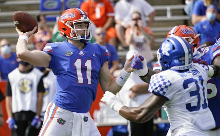 Florida quarterback Kyle Trask (11) throws a pass as Kentucky linebacker Jamar Watson (31) rushes on Saturday in Gainesville. (JOHN RAOUX/Associated Press)