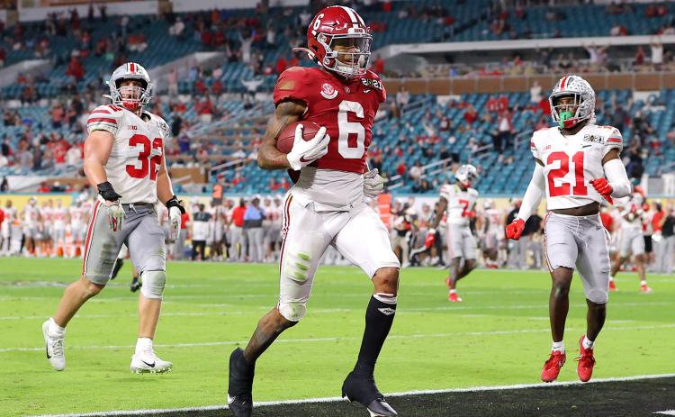 Alabama Crimson Tide receiver DeVonta Smith rushes for a 42-yard touchdown against the Ohio State Buckeyes during the College Football Playoff National Championship game on Monday in Miami Gardens. (KEVIN C. COX/Getty Images/TNS)