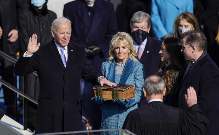 U.S. President-elect Joe Biden takes the oath of office from Supreme Court Chief Justice John Roberts as his wife U.S. First Lady-elect Jill Biden stands next to him during the 59th presidential inauguration on Wednesday in Washington, D.C. (KENT NISHIMURA/Los Angeles Times/TNS)