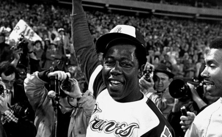 Hank Aaron celebrates after his 715th career home run in 1974. (AP FILE PHOTO)