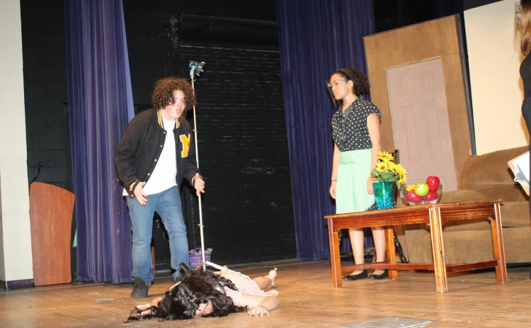 Nick Stewart reacts to Rose Brocchi playing a dead woman during dress rehearsal for the Columbia High dinner/theater production of ‘The Bold, the Young, and the Murdered.’ The CHS drama club and culinary arts program will host the play tonight and tomorrow at the Norman L. Choice Performing Arts Center. (TONY BRITT/Lake City Reporter)