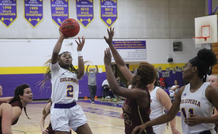 Columbia guard Na’Haviya Paxton puts up a shot over Oak Hall guard Tyla Young during Friday night’s game. Paxton had a triple-double with 20 points, 10 rebounds and 10 assists. (JORDAN KROEGER/Lake City Reporter)