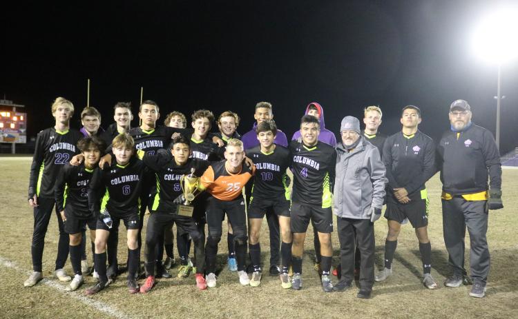 Columbia’s soccer team poses with the Three Rivers Cup after defeating Santa Fe 2-1 at home on Friday. (TONY BRITT/Lake City Reporter)