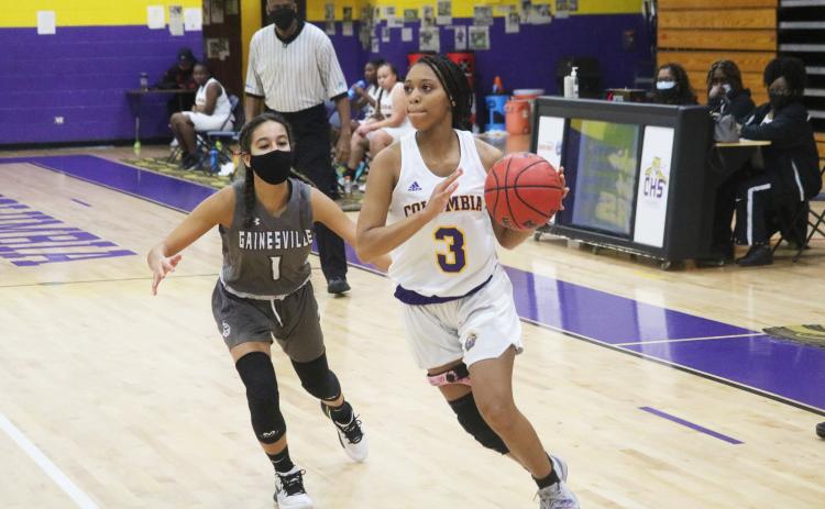 Columbia guard Camille Perry drives past Gainesville guard Layla Canales on Wednesday night. (JORDAN KROEGER/Lake City Reporter)