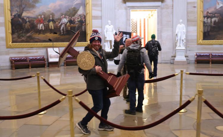 Adam Johnson, 36, of Parrish, faces felony charges after he was seen carrying House Speaker House Nancy Pelosi’s lectern through the U.S. Capitol on Jan. 6. (WIN McNAMEE/Getty Images/TNS)