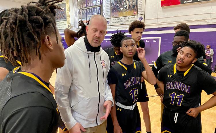 Columbia coach Steve Faulkner listens to senior Dante Brown during a second-half huddle Tuesday night. (SCOTT LAPEER/Special to the Reporter)