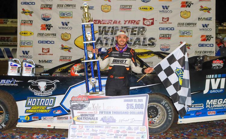 Kyle Larson poses with the first-place trophy after winning the General Tire Winter Nationals at All-Tech Raceway on Saturday night. Larson received a prize of $15,000. (LOVIN’ DIRTY PHOTOGRAPHY )