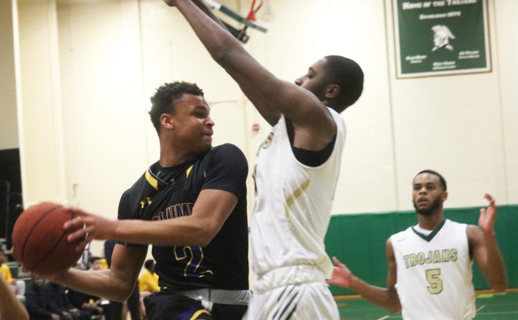 Columbia guard Amare Ferrell’s drive is stopped by a Lincoln defender Tuesday night in the Region 1-6A semifinals. (JORDAN KROEGER/Lake City Reporter)