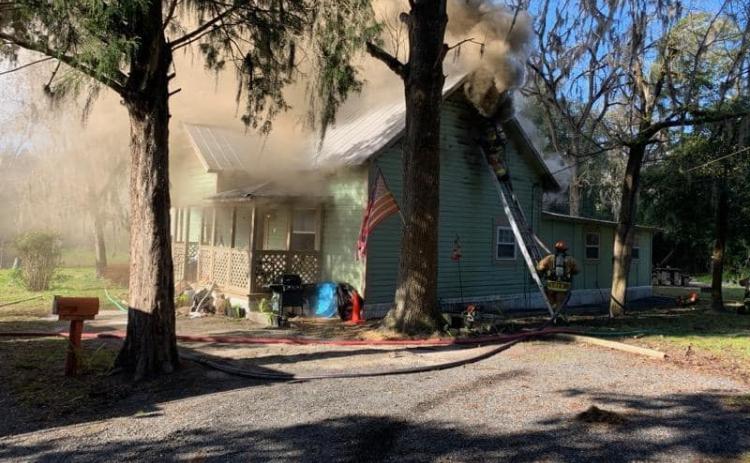 Firefighters with the Live Oak Fire Department battle a house fire on Lisle Ave. NE on Monday morning. The house sustained ‘considerable damage.’ (COURTESY SUWANNEE COUNTY FIRE RESCUE)